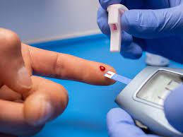 A person is holding a blood sample in their hand.