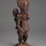A statue of a woman with a bird on her head.