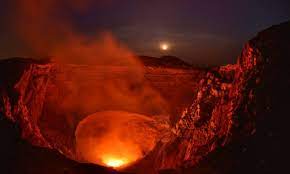 A crater with a fire and smoke coming out of it.